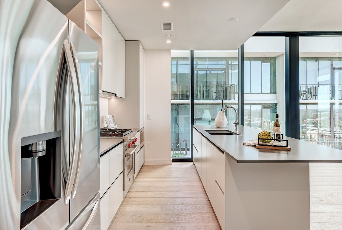 610 Davis Street, Unit 3008 Austin, TX 78701 - Photo 8 of 39 a kitchen with stainless steel appliances granite countertop a refrigerator and a sink