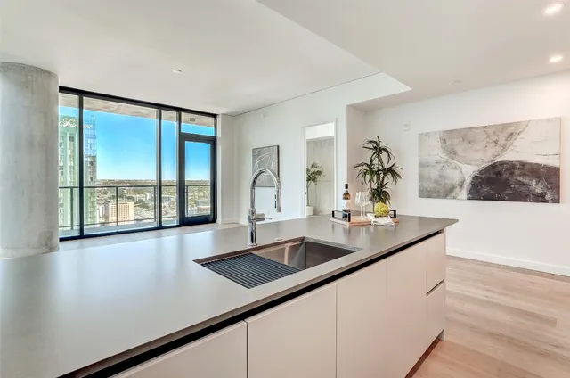 a kitchen with stainless steel appliances granite countertop a refrigerator and a sink