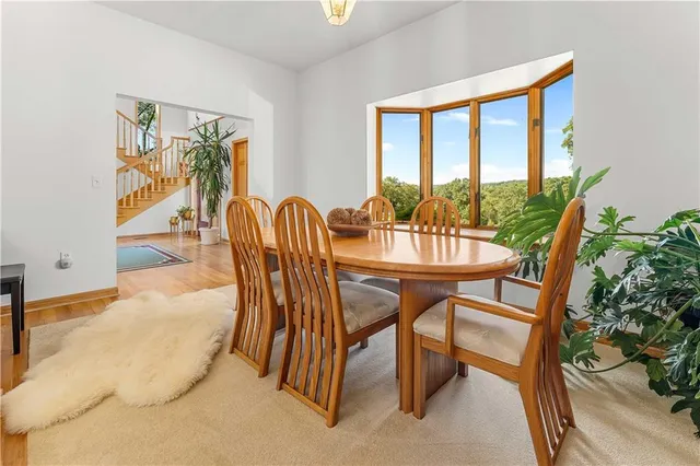 a dining room with furniture and a floor to ceiling window
