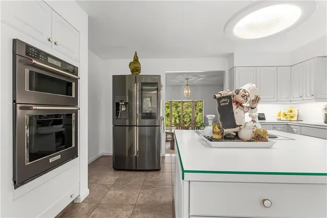 a kitchen with a refrigerator and a stove