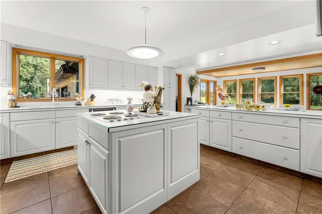 a kitchen with a sink window and cabinets