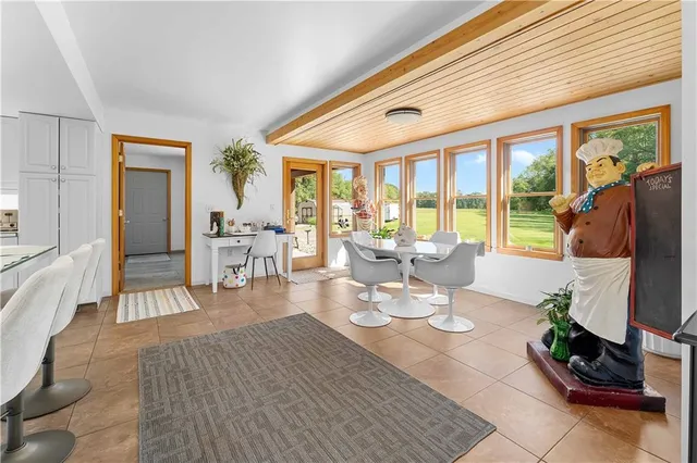 a living room with furniture a wooden floor and a flat screen tv