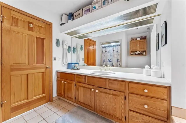 a spacious bathroom with a granite countertop sink mirror and
