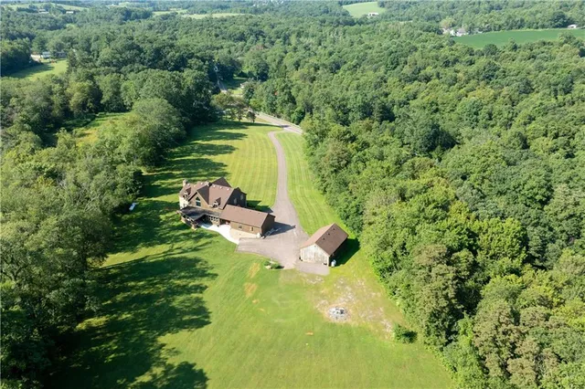 a backyard of a house with a yard and outdoor seating