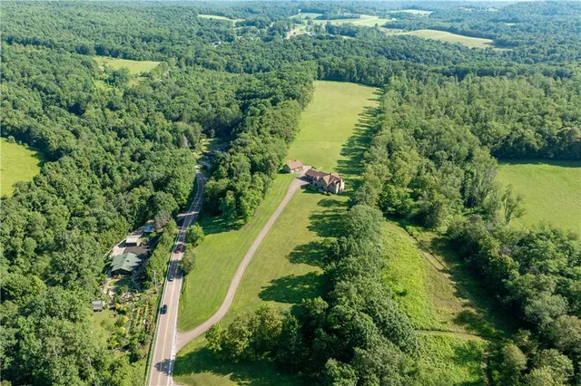 a view of a green yard with a lake view