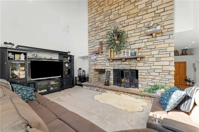 a living room with fireplace furniture and a flat screen tv