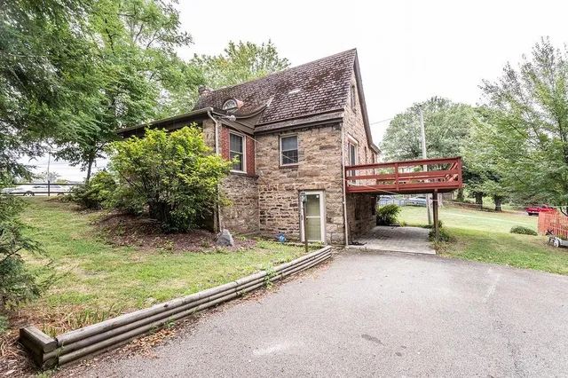 a backyard of a house with yard and trampoline