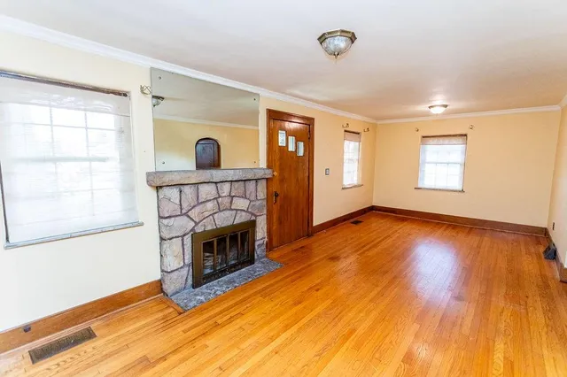 a view of a room with wooden floor and windows