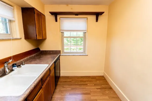 a kitchen with stainless steel appliances granite countertop a refrigerator and a stove