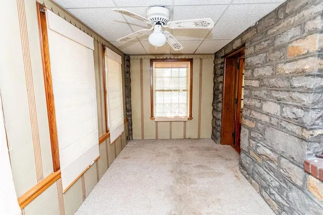a view of a livingroom with wooden floor and window