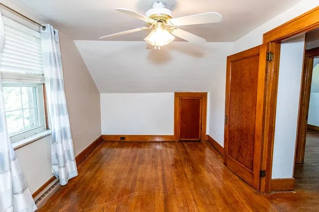 an empty room with closet and a chandelier fan