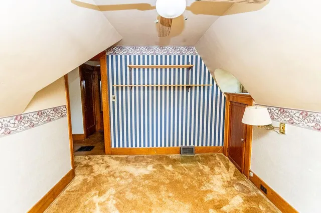 a view of water heater room with wooden floor