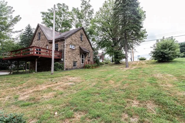 a view of a house with a yard and garage
