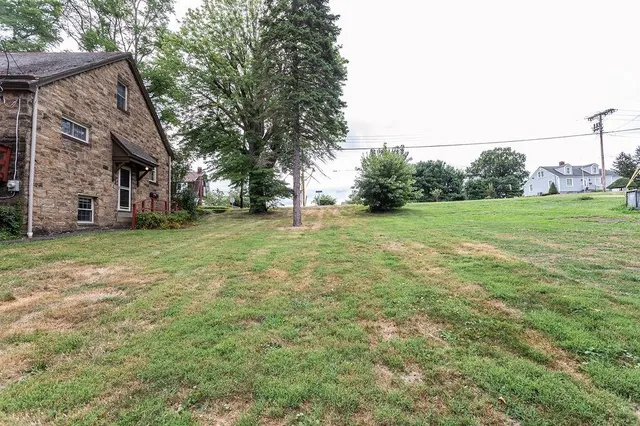 a view of a field of grass and trees