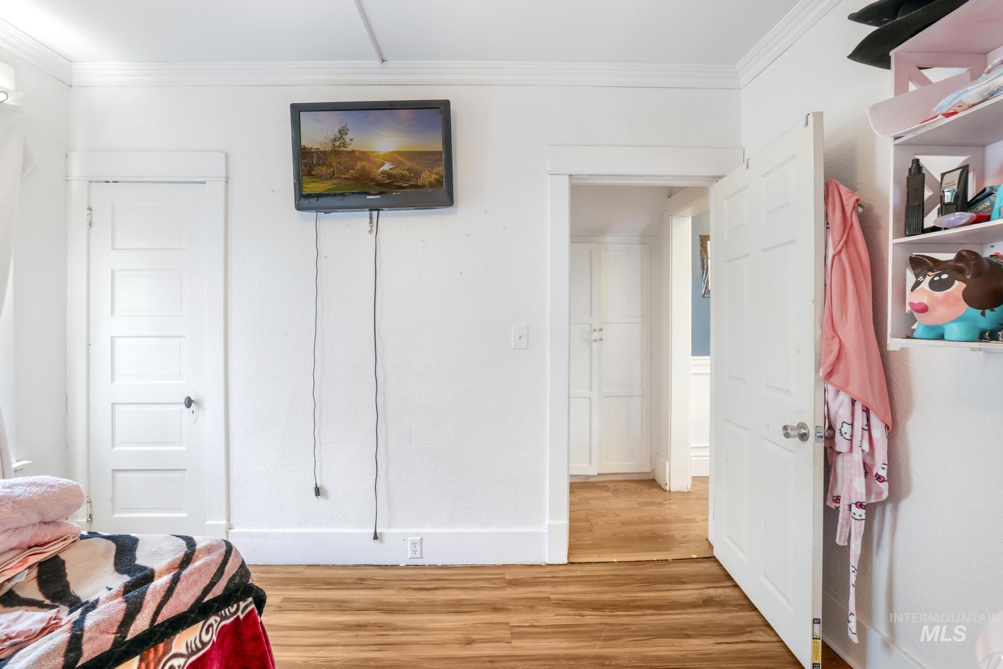242 8th Avenue East Twin Falls, ID 83301 - Photo 15 of 35 Bedroom with ornamental molding and wood finished floors