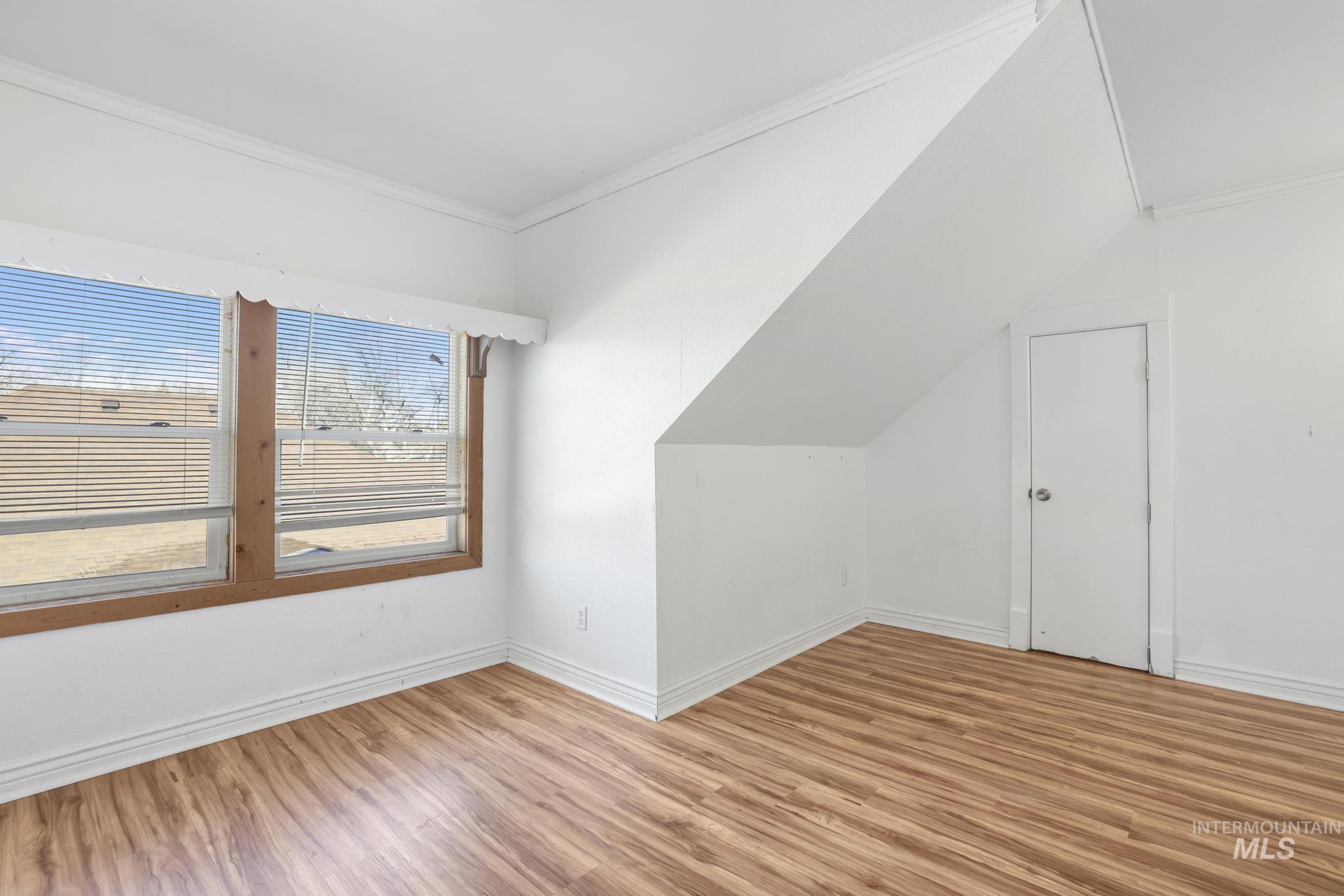 242 8th Avenue East Twin Falls, ID 83301 - Photo 19 of 35 Additional living space with wood finished floors and vaulted ceiling
