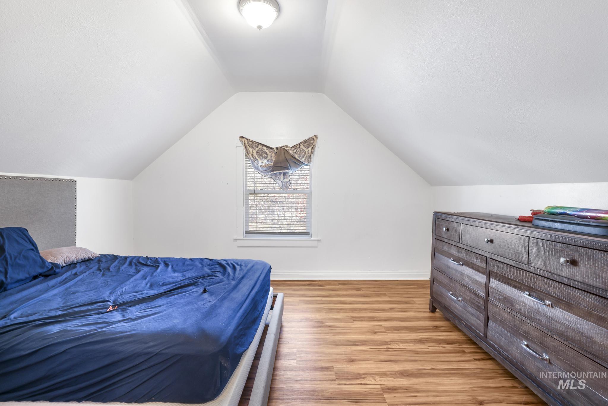 242 8th Avenue East Twin Falls, ID 83301 - Photo 20 of 35 Bedroom with light wood finished floors and vaulted ceiling