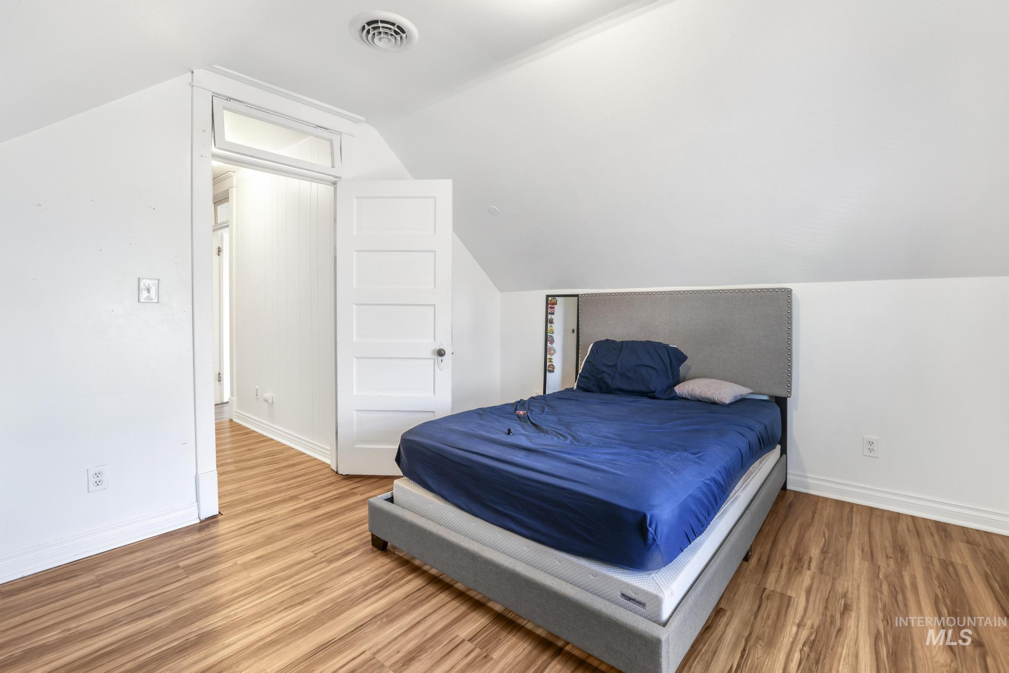 242 8th Avenue East Twin Falls, ID 83301 - Photo 21 of 35 Bedroom with light wood-type flooring and lofted ceiling