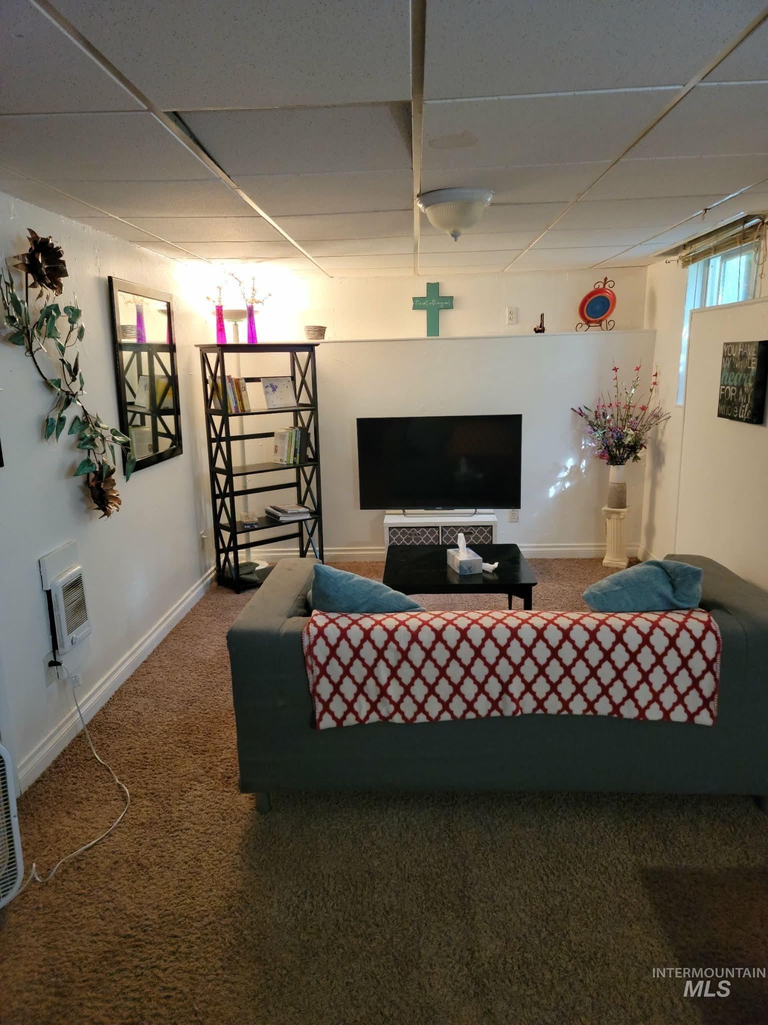 242 8th Avenue East Twin Falls, ID 83301 - Photo 24 of 35 Carpeted living area with a paneled ceiling and heating unit