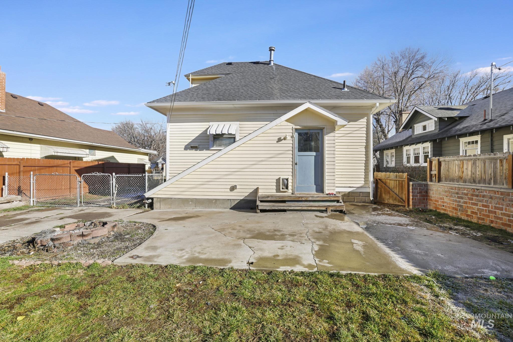 242 8th Avenue East Twin Falls, ID 83301 - Photo 34 of 39 Back of property featuring a gate, a patio, and a shingled roof