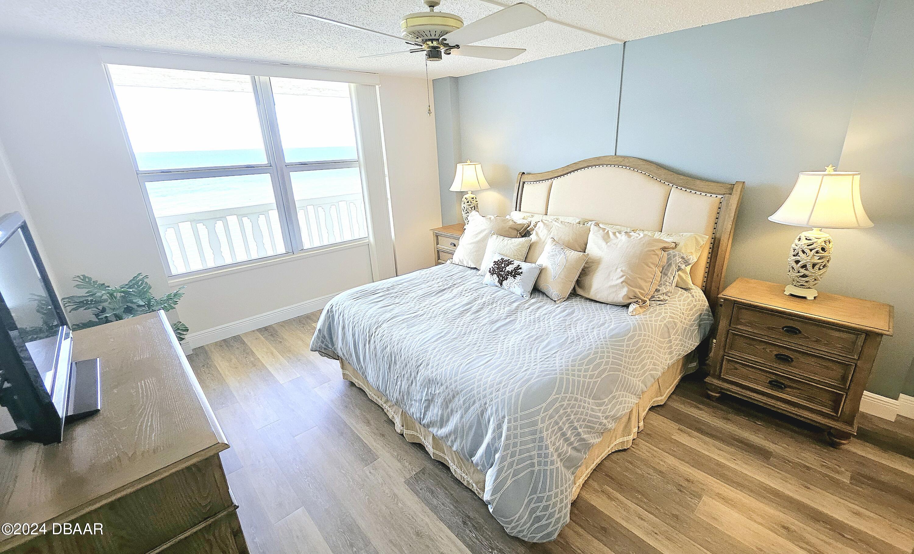 1575 Ocean Shore Boulevard, Unit 1003 Ormond Beach, FL 32176 - Photo 13 of 40 a bedroom with beds and a large window