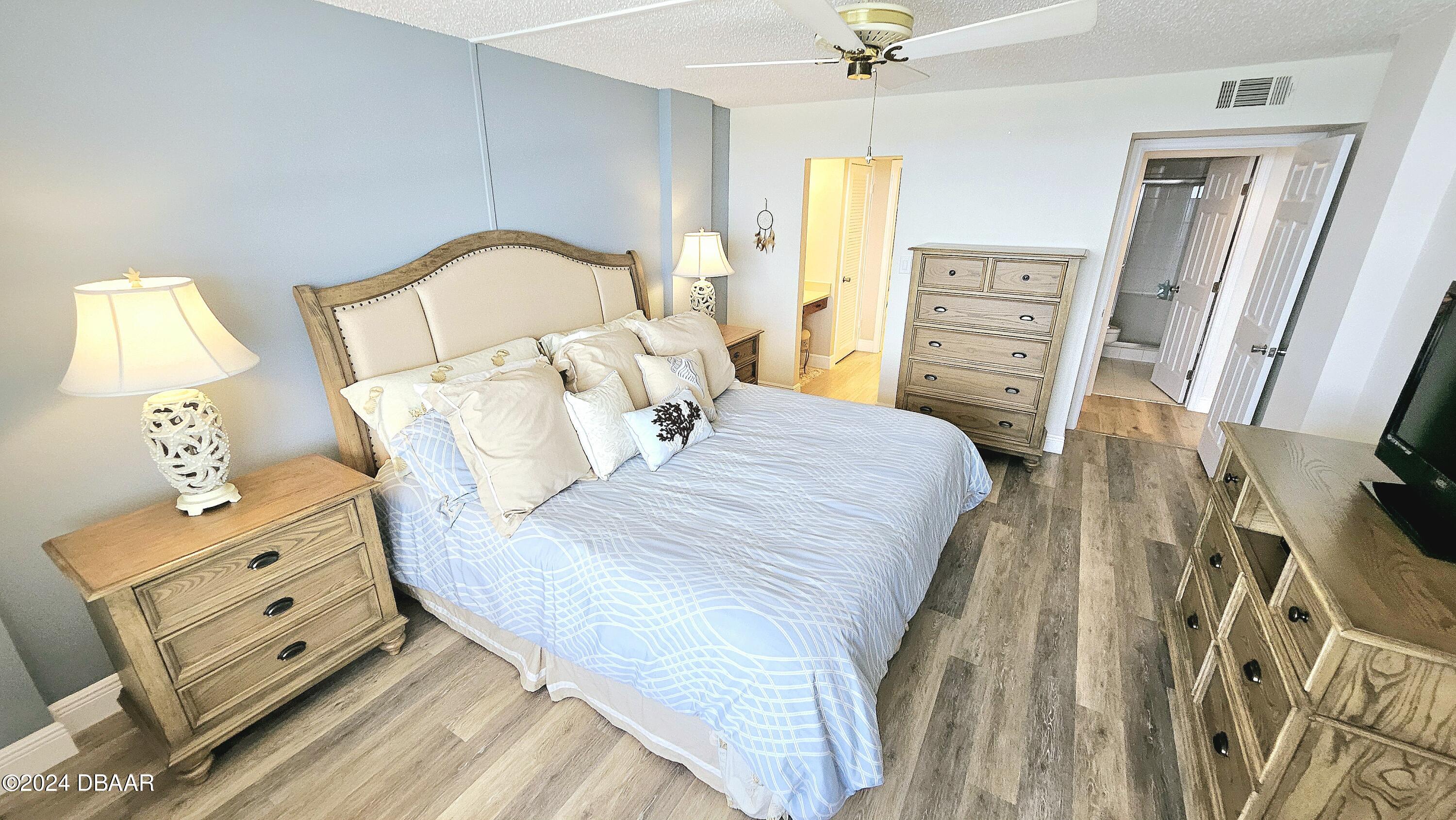 1575 Ocean Shore Boulevard, Unit 1003 Ormond Beach, FL 32176 - Photo 14 of 40 a bedroom with a bed and a dresser