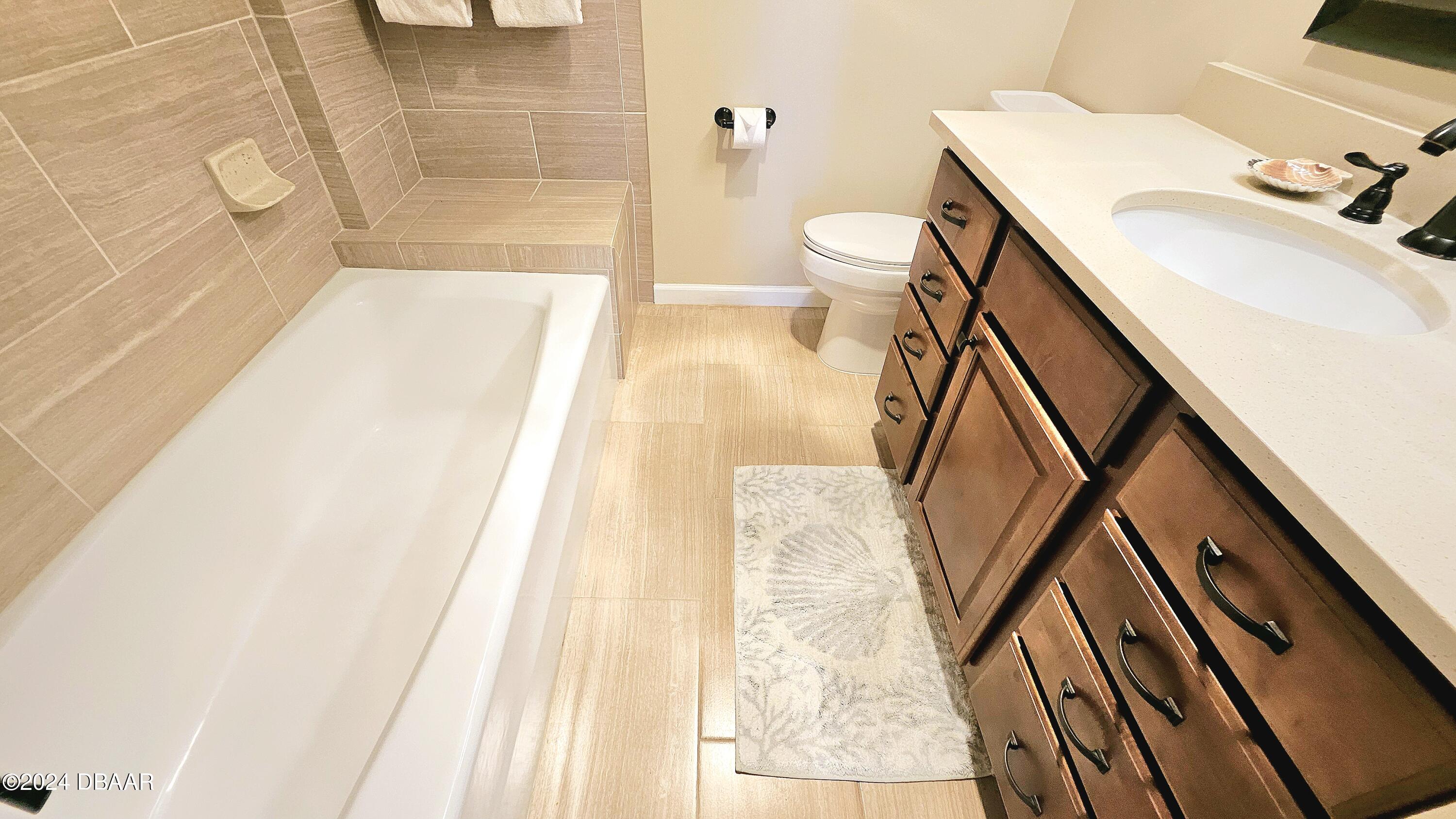 1575 Ocean Shore Boulevard, Unit 1003 Ormond Beach, FL 32176 - Photo 18 of 40 a bathroom with a sink and a mirror