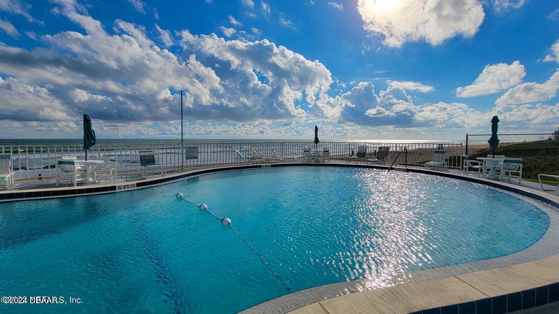 1575 Ocean Shore Boulevard, Unit 1003 Ormond Beach, FL 32176 - Photo 2 of 40 a view of a swimming pool and outdoor space