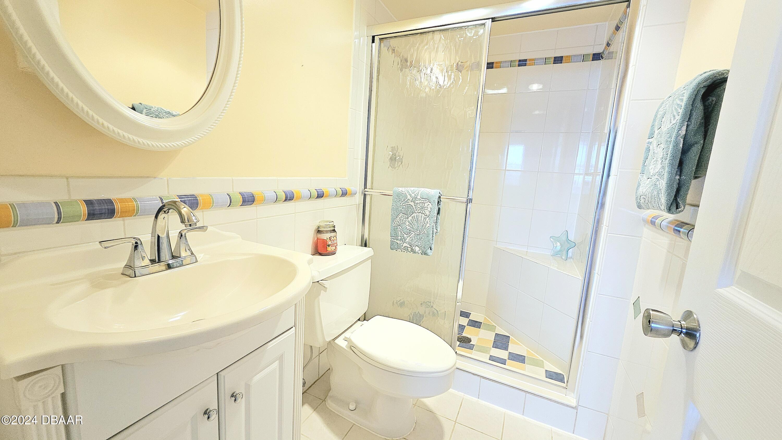 1575 Ocean Shore Boulevard, Unit 1003 Ormond Beach, FL 32176 - Photo 24 of 40 a bathroom with a sink a toilet and a mirror
