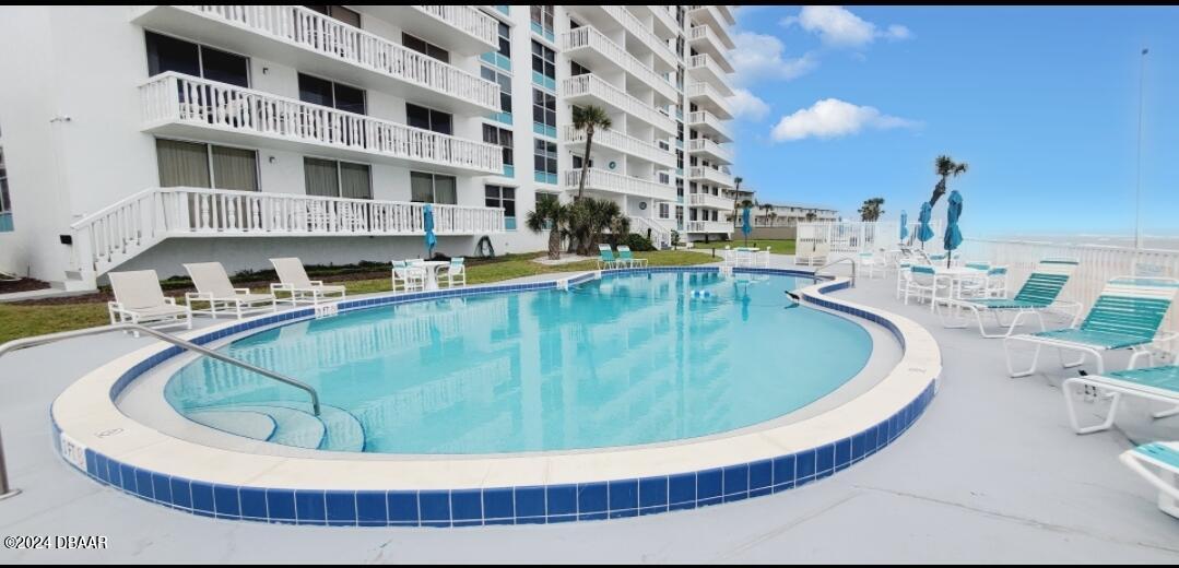1575 Ocean Shore Boulevard, Unit 1003 Ormond Beach, FL 32176 - Photo 27 of 40 a view of a swimming pool with outdoor seating