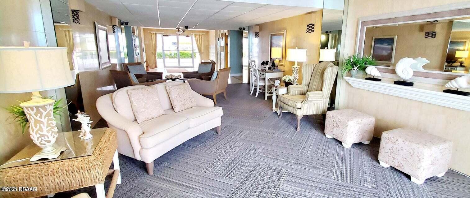 1575 Ocean Shore Boulevard, Unit 1003 Ormond Beach, FL 32176 - Photo 35 of 40 a living room with furniture and a large window