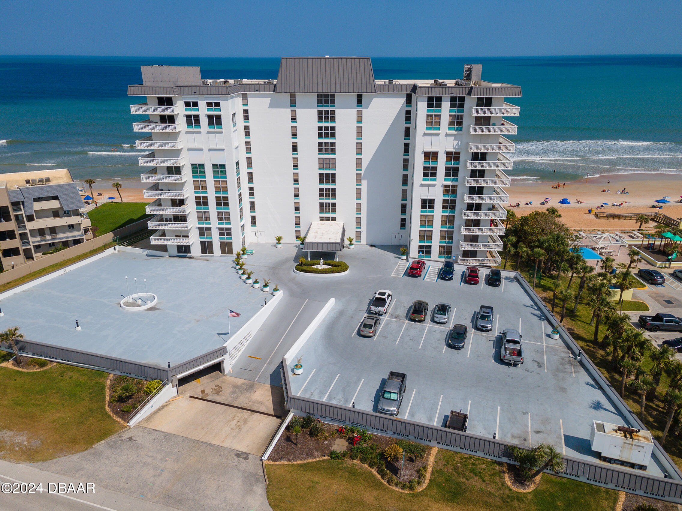 1575 Ocean Shore Boulevard, Unit 1003 Ormond Beach, FL 32176 - Photo 37 of 40 a view of a pool with chairs and plants