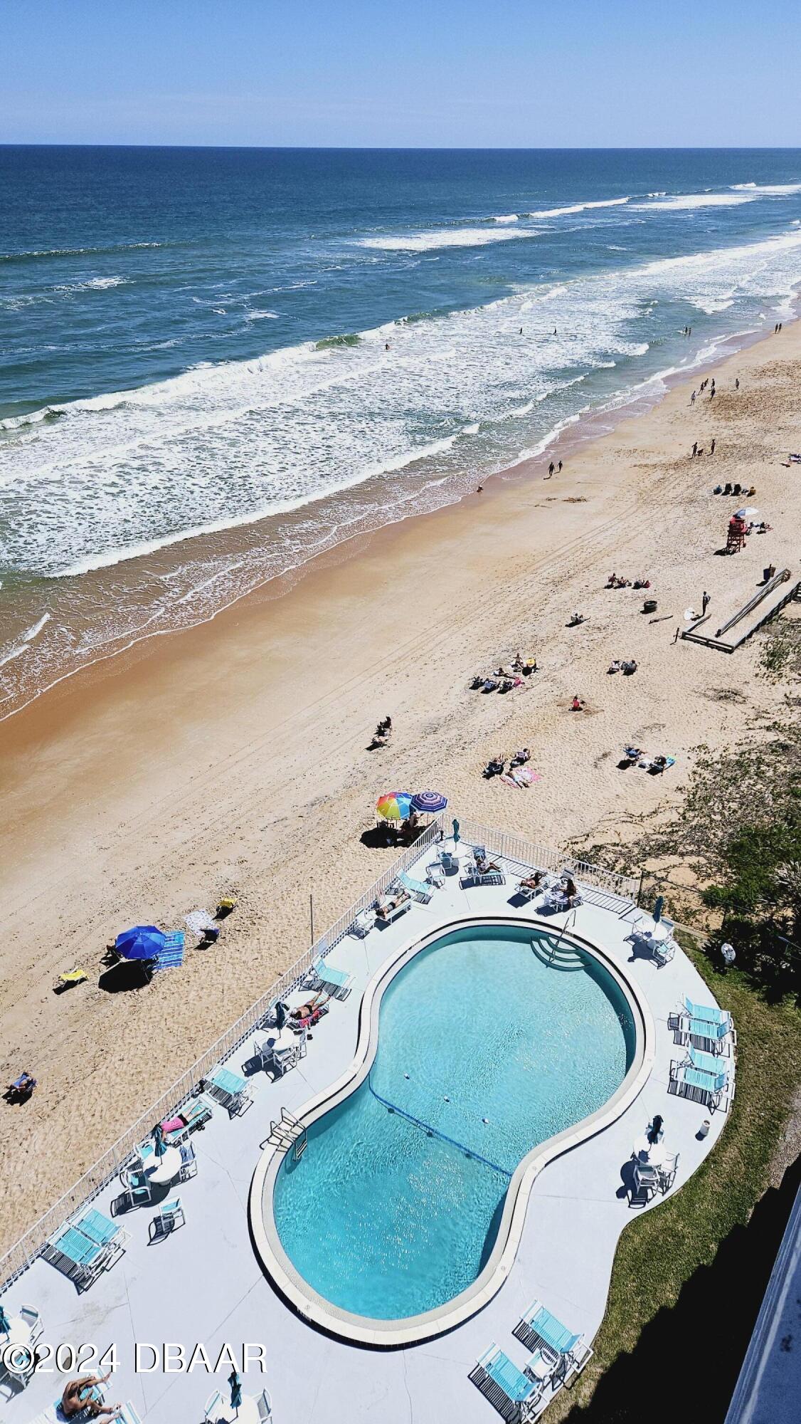 1575 Ocean Shore Boulevard, Unit 1003 Ormond Beach, FL 32176 - Photo 38 of 40 a view of a swimming pool with outdoor seating