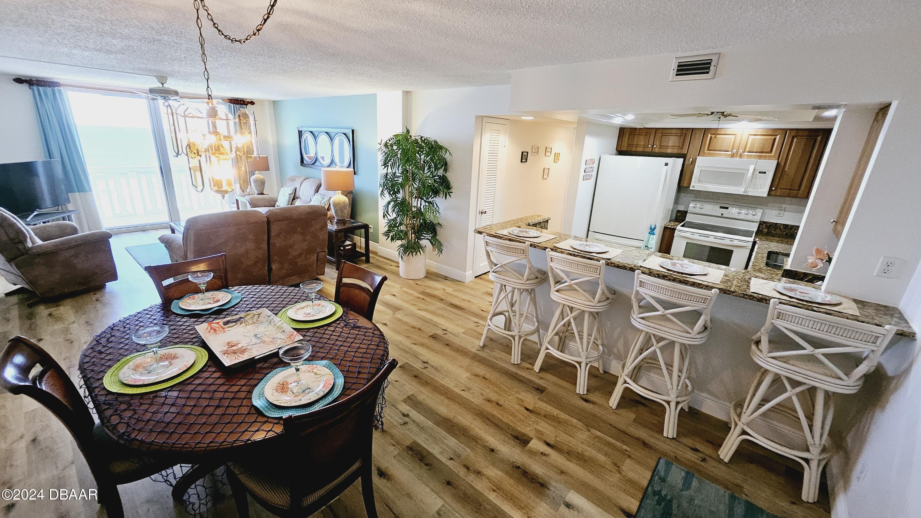 1575 Ocean Shore Boulevard, Unit 1003 Ormond Beach, FL 32176 - Photo 8 of 40 a view of a dining room with furniture