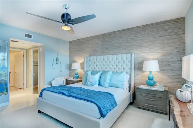 a bedroom with a bed and a chandelier