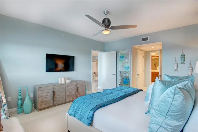 a bedroom with a bed and a television