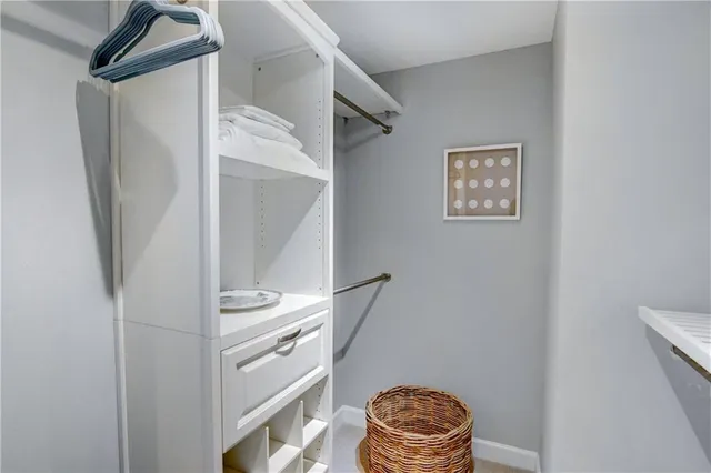 a living room with furniture and a painting on the wall