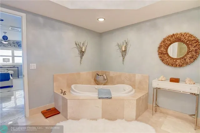 a living room with furniture and a painting on the wall