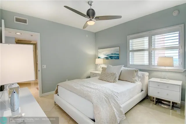 a kitchen with stainless steel appliances kitchen island granite countertop a sink and a refrigerator