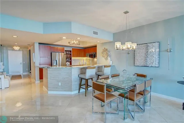 a view of swimming pool with outdoor seating and a garden