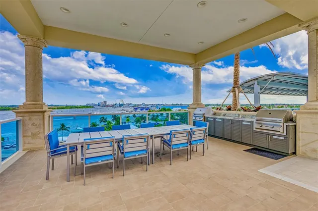 an aerial view of a house with a yard and outdoor seating