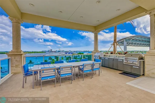 an aerial view of a house with a yard and outdoor seating