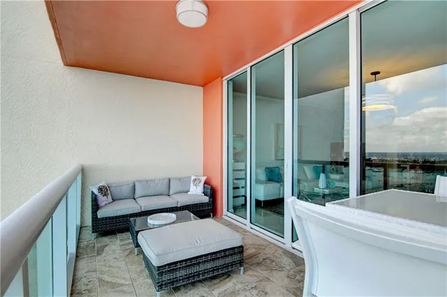 a bedroom with a bed a desk and chair with window