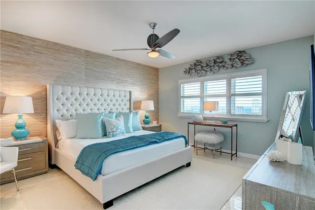 a very nice looking dining room with a large window and chandelier
