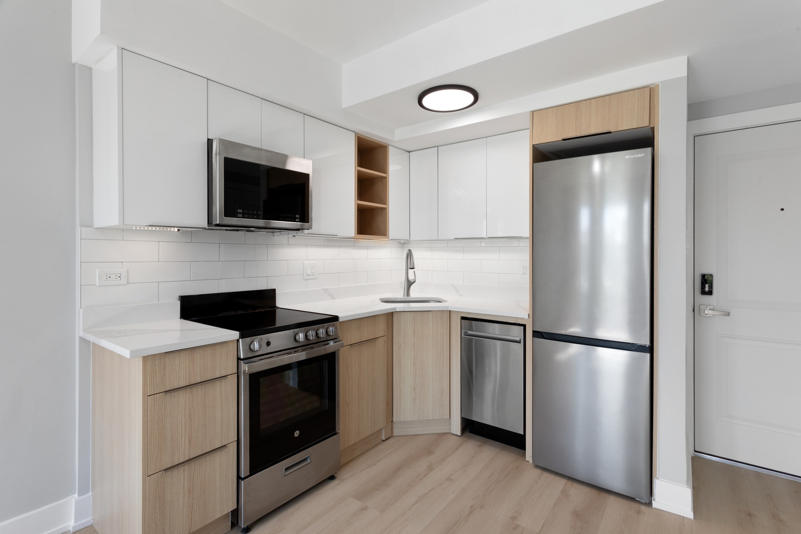1634 West Howard Street, Unit 314 Chicago, IL 60626 - Photo 4 of 8 a kitchen with a refrigerator stove and microwave