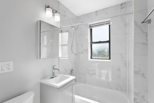 a bathroom with a sink toilet and shower