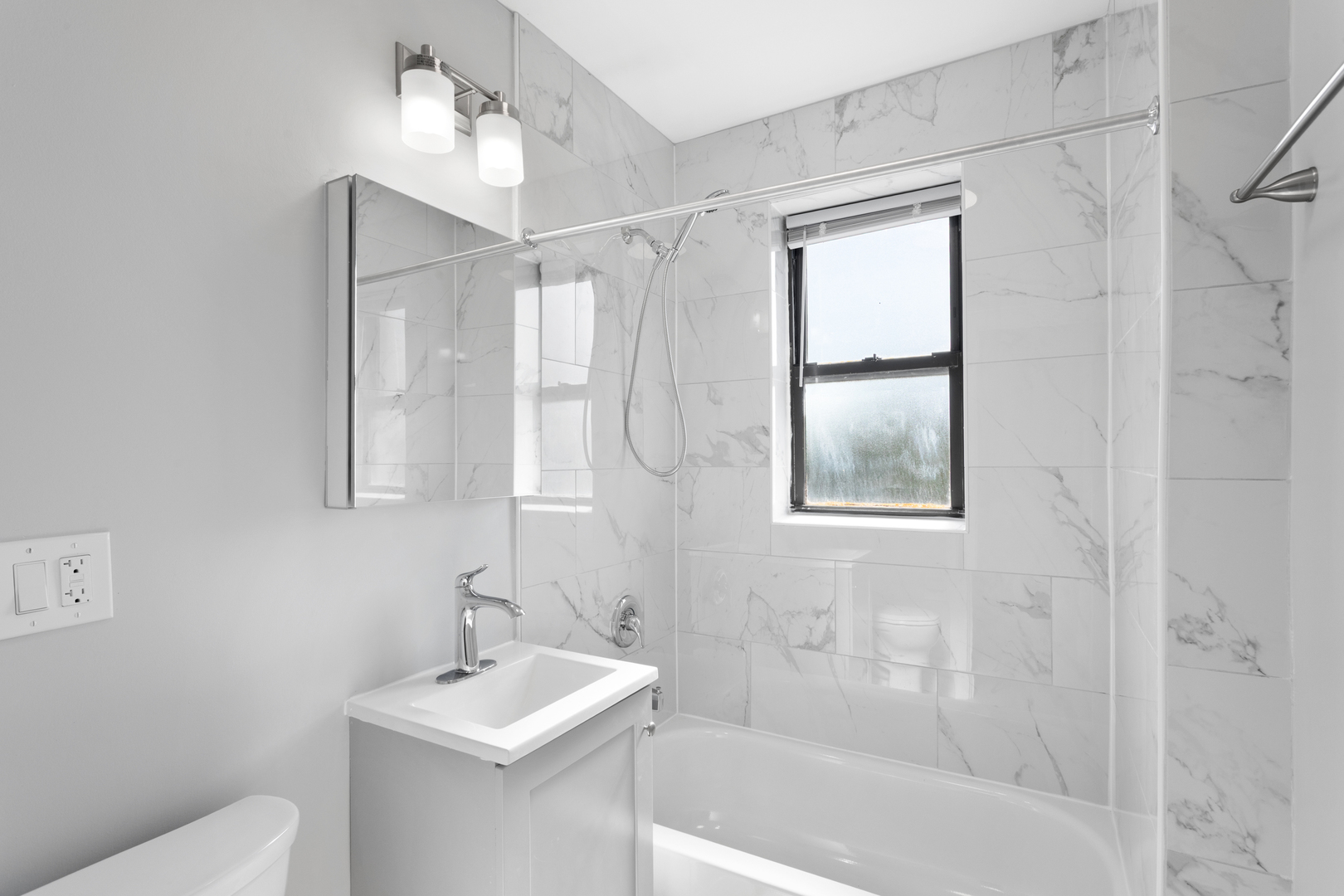 1634 West Howard Street, Unit 314 Chicago, IL 60626 - Photo 7 of 8 a bathroom with a sink toilet and shower