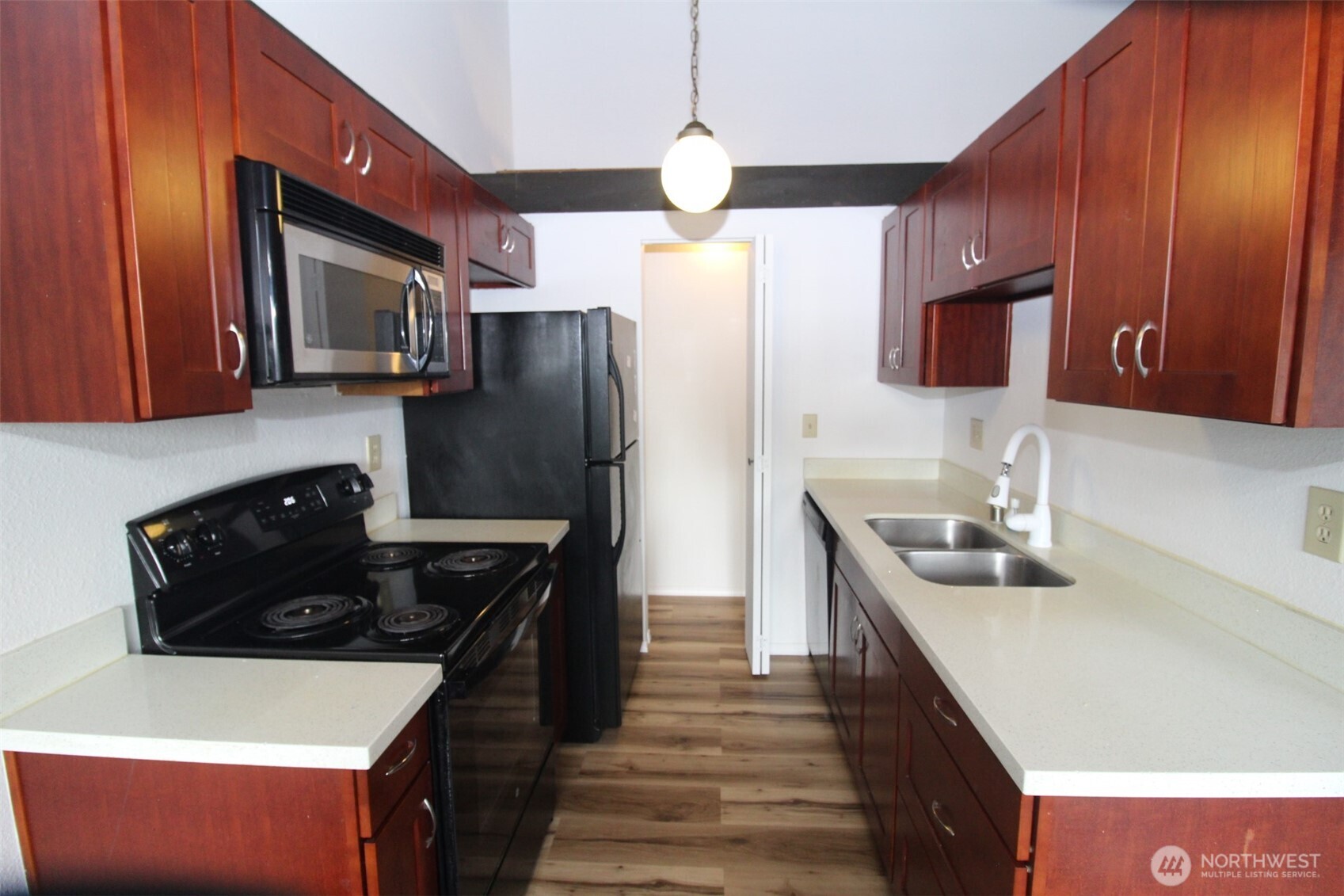 15210 Macadam Road South, Unit D304 Tukwila, WA 98188 - Photo 3 of 23 a kitchen with stainless steel appliances granite countertop a sink stove and refrigerator