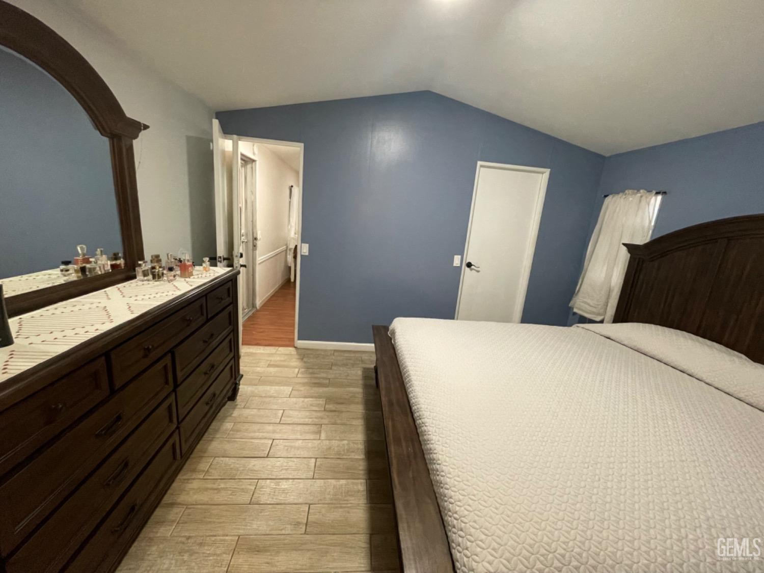 Undisclosed Address Bakersfield, CA 93304 - Photo 11 of 24 a room with a bed and a mirror