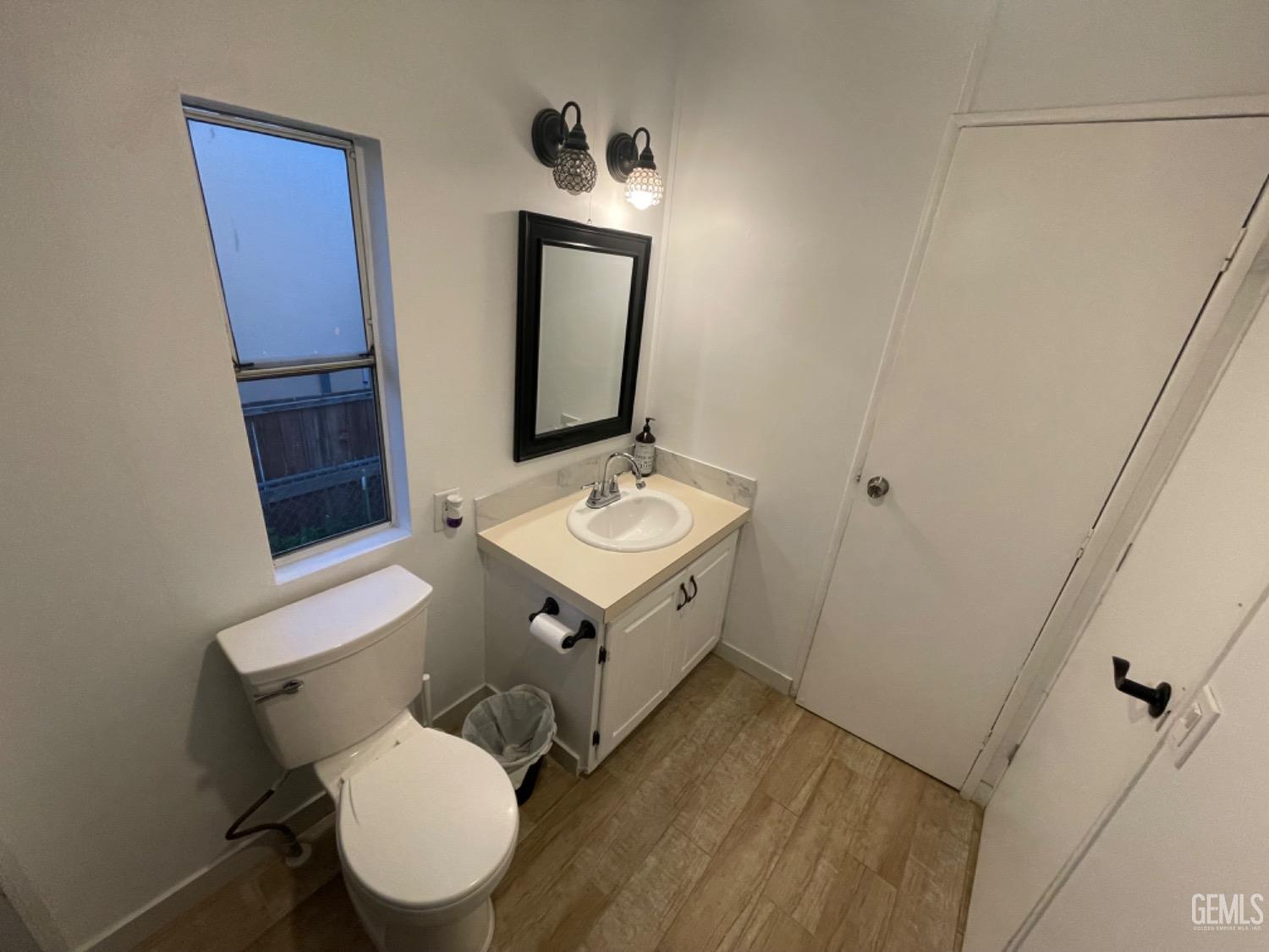 Undisclosed Address Bakersfield, CA 93304 - Photo 12 of 24 a bathroom with a toilet a sink and mirror